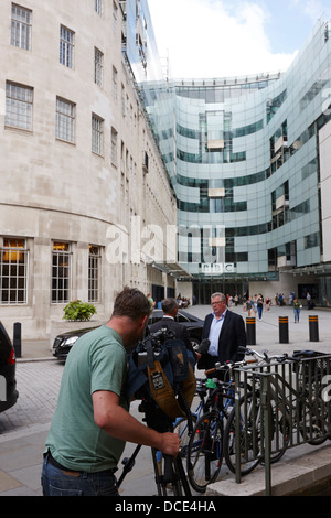 Troupe televisiva conducendo intervista al di fuori del BBC Broadcasting House Londra Inghilterra REGNO UNITO Foto Stock