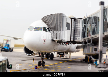 Un aereo fermo a Charles de Galle aeroporto, Paris, Francia. Imbarco passeggeri al piano a piedi attraverso una jetway. Foto Stock