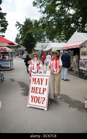 Due donne amichevole sono pronti ad aiutare i visitatori all'entrata del Saratoga Raceway in Saratoga, New York. Foto Stock