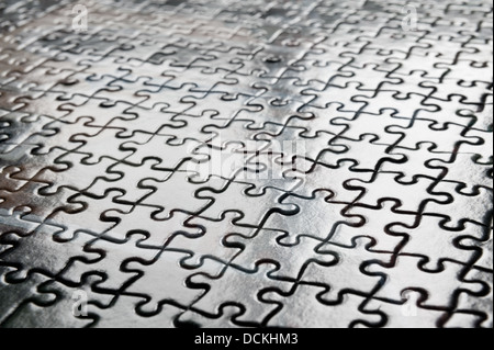 Puzzle di pezzi ad incastro pattern per risolvere ingranato insieme in un esito corretto come ogni pezzo una forma unica Foto Stock