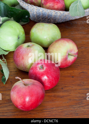 Più rosso e mele verdi sul tavolo di legno vicino fino Foto Stock