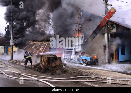 Fireman controllare un immenso incendio Foto Stock