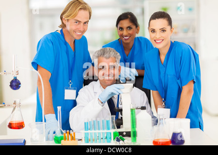 Allegro senior scientist con un gruppo di studenti di chimica in laboratorio Foto Stock