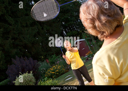 Due donne riproduzione di badminton in giardino Foto Stock