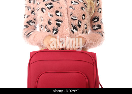 Modello rilasciato. donna giovane con una valigia rossa Foto Stock