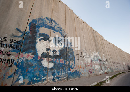 Un murale di Che Guevara copre la separazione israeliano nel muro della città palestinese di Abu Dis. Foto Stock