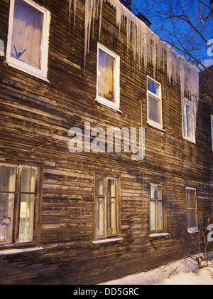 Ghiaccioli sul tetto di una casa in legno Foto Stock