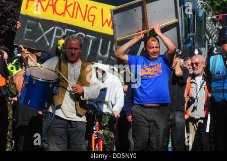 Balcombe, West Sussex, Regno Unito. Il 27 agosto, 2013. Il primo camion dopo Bank Holiday break arriva a Balcombe a 10am martedì mattina per essere condotti su Cuadrilla sito di perforazione dalla polizia con anti fracking manifestanti a piedi nella parte anteriore con striscioni e cartelloni di protesta.Il camp è in crescita in dimensioni di più tende appaiono. Il anti fracking attivisti protestano contro la perforazione da Cuadrilla sul sito in West Sussex Credito: David Burr/Alamy Live News Foto Stock