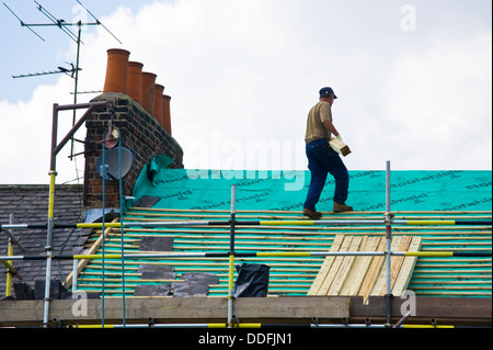 Builder a lavorare sul tetto della casa d'epoca nella città di York North Yorkshire England Regno Unito Foto Stock