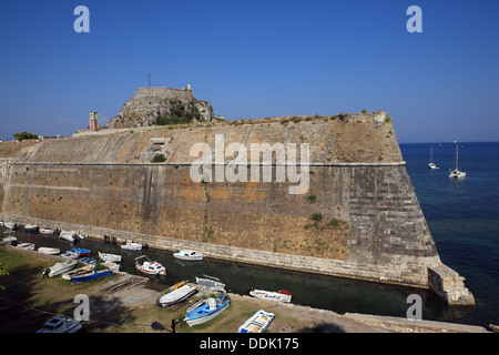Le alte e ripide mura di difesa della fortezza vecchia di Corfù città in Grecia che è costruita su una penisola rocciosa. Foto Stock
