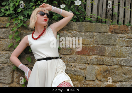 Giovane donna della modellazione di un bianco abito skater Foto Stock