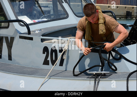 JEBEL ALI, Emirati arabi uniti (sett. 03, 2013) Electronics tecnico di terza classe Joshua Reeves, assegnato al comandante del gruppo di attività (CTG) 56,7, proietta fuori di una riga da una imbarcazione di pattuglia come essa si allontana dalla Jebel Ali. CTG 56,7 conduce la sicurezza marittima operatio Foto Stock