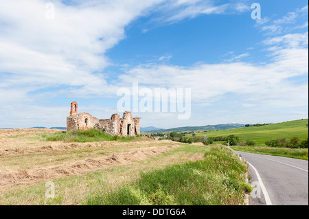 Fattoria abbandonata lungo la strada di campagna in Toscana Foto Stock