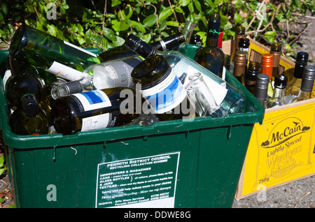 Bottiglie in un contenitore di riciclaggio al di fuori di una casa nel Regno Unito Foto Stock