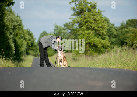 Donna con un Malinois o pastore belga cane Foto Stock