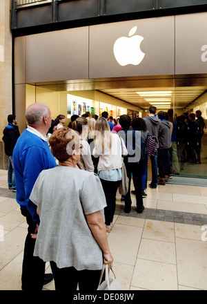 La gente in una coda in coda al di fuori del negozio Apple di Grand Arcade shopping centre, Cambridge Regno Unito Foto Stock