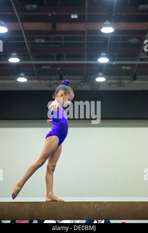 Detroit, Michigan - una ragazza compete sul fascio di equilibrio durante l'AAU Junior Giochi Olimpici. Foto Stock