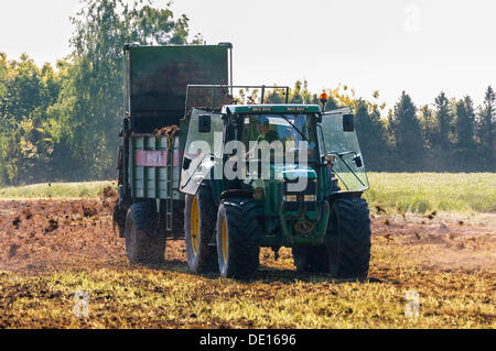 Trattore con dispersore per letame, agricoltore lavora nei campi, spandimento del letame, Götzenhain, Dreieich, Hesse, Germania Foto Stock