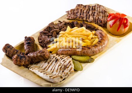 Vassoio rustico con vari tipi di carne, patatine fritte e ortaggi assortiti Foto Stock