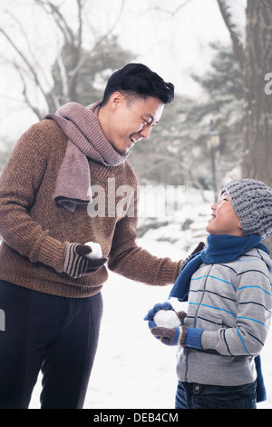 Padre e figlio azienda snowballs Foto Stock