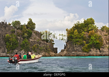 I turisti in una barca, Raja Ampat, Papua occidentale, in Indonesia Foto Stock