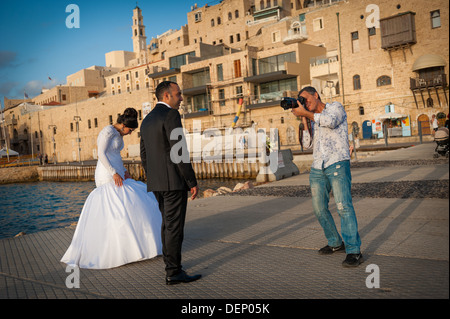 Una giovane coppia il loro giorno di nozze che è fotografata al vecchio porto di Jaffa in Israele Foto Stock
