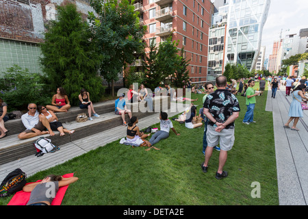 Per coloro che godono di una posizione soleggiata giornata presso l'alta linea parco pubblico elevato sopra le strade di Manhattan sul lato ovest Foto Stock