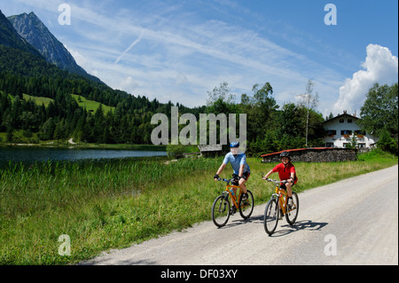 Gita in bicicletta con la mountain bike, il padre e il figlio al Lago Ferchensee, Mittenwald, montagne Karwendel, Werdenfelser Land Foto Stock