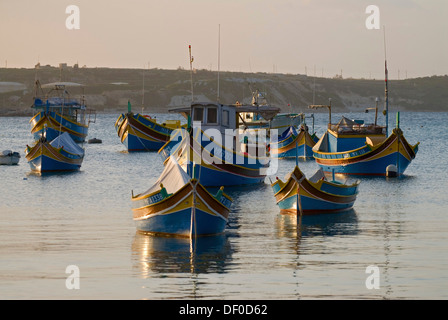 Luzzus, il tipico coloratissime barche di pescatori di Malta, nel porto di Marsaxlokk, Malta, Europa Foto Stock