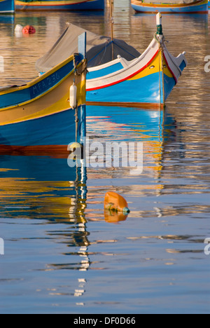 Luzzus, il tipico coloratissime barche di pescatori di Malta, nel porto di Marsaxlokk, Malta, Europa Foto Stock