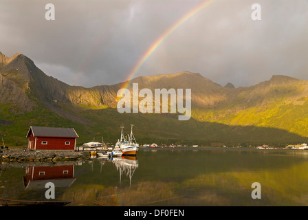 Un arcobaleno sopra il mare di Norvegia vicino Grashopen e alcune barche da pesca riflessa fuori l'isola di Senja, Troms, Norvegia, Europa Foto Stock