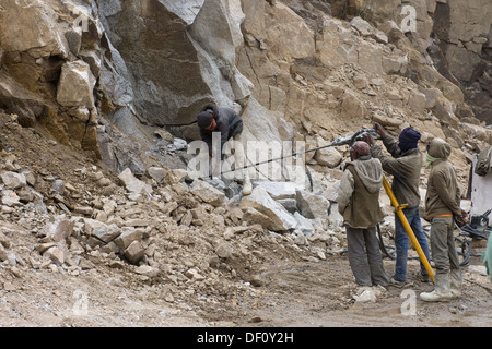 I lavoratori stradali la trapanatura di un foro per esplosivi senza alcuna protezione, nella parte superiore della Khardang La pass, nei pressi di Leh, (Ladakh) Jammu e Kashmir India Foto Stock