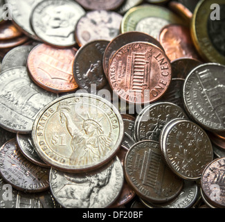 Close up su una pila di monete americano US soldi con il fuoco principale su un Dollaro moneta Foto Stock