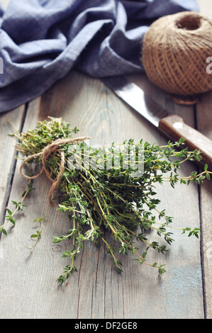 Mazzetto di timo fresco su sfondo di legno Foto Stock