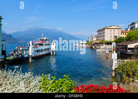 Il lago di Como. Traghetto lo scarico nel dock con Hotel storico Genazzini / Metropole sul lungomare a destra, Bellagio,Lombardia, Italia Foto Stock