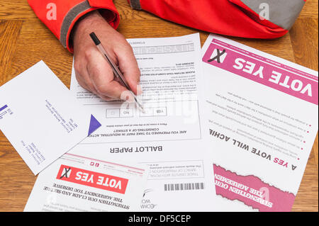 Regno Unito. 28 Settembre, 2013. Un Royal Mail portalettere dipendente spuntando la casella Sì per colpire l'azione industriale su ufficiali nazionali del voto cartaceo. Credito: T.M.O.News/Alamy Live News Foto Stock