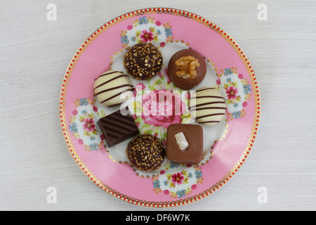 Selezione di cioccolatini sul rosa la piastra di porcellana Foto Stock