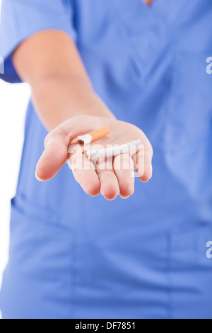 African American nurse tenendo la rottura di una sigaretta, isolati su sfondo bianco - nero di persone Foto Stock