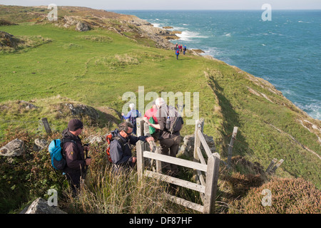 Gruppo di Welsh escursionisti a piedi a ovest sul sentiero costiero da Llaneilian a Amlwch sull isola di Anglesey, Galles del Nord, Regno Unito, Gran Bretagna Foto Stock