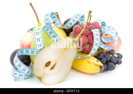Metro a nastro e composizione di frutta su uno sfondo bianco Foto Stock