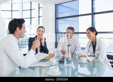 I medici e la gente di affari di parlare in riunione Foto Stock