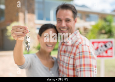 Ritratto di Coppia sorridente tenendo le chiavi di casa Foto Stock