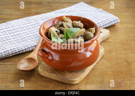 Ragù di funghi di champignon e basilico su un tavolo di legno Foto Stock