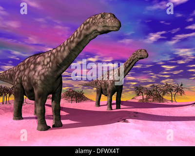 Due Argentinosaurus dinosauri in un paesaggio preistorico con colorati sky. Foto Stock