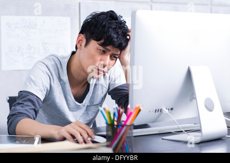 Preoccupato per il giovane uomo in ufficio Foto Stock