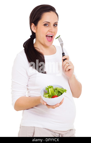 Bella giovane donna mangiare insalata verde isolato su bianco Foto Stock