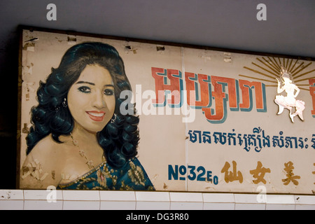 Un segno dipinto mostra una donna e scritto in Khmer e il cinese si blocca al di sopra di un salone di bellezza in Phnom Penh Cambogia. Foto Stock