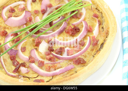 Cipolla fresca crostata con i porri e la pancetta su uno sfondo luminoso Foto Stock