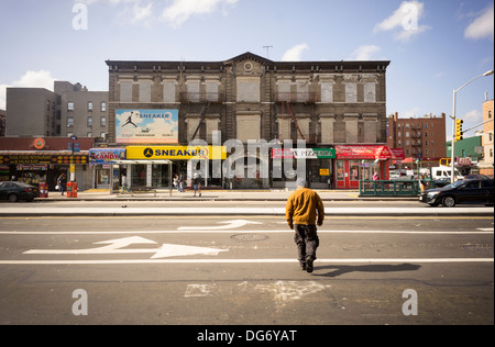 Esercizi di commercio al dettaglio in un sigillato edificio sulla Lenox Avenue in Harlem in New York Foto Stock