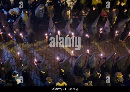 I penitenti incappucciati recanti candele sul Buon Venerdì, Siviglia, Spagna Foto Stock